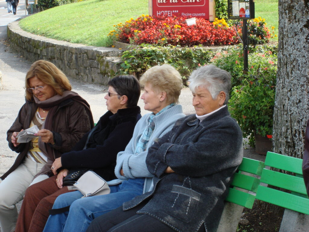 women on park bench growing old